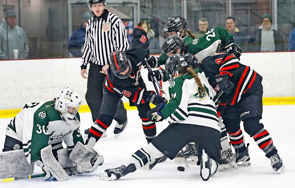 A pile-up in front of Rams goalie Morgan Murphy as both teams look for the loose puck.
The Marshfield Rams hosted the Hingham Harborwomen in ice hockey at The Bog in Kingston on Wednesday January 21, 20126