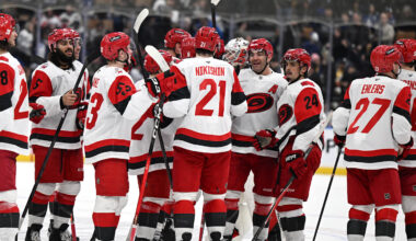 Mar 20, 2026; Toronto, Ontario, CAN;  Carolina Hurricanes defenseman Alexander Nikishin (21) is congratulated by team mates after scoring the winning goal in overtime against the Toronto Maple Leafs at Scotiabank Arena. Mandatory Credit: Dan Hamilton-Imagn Images
