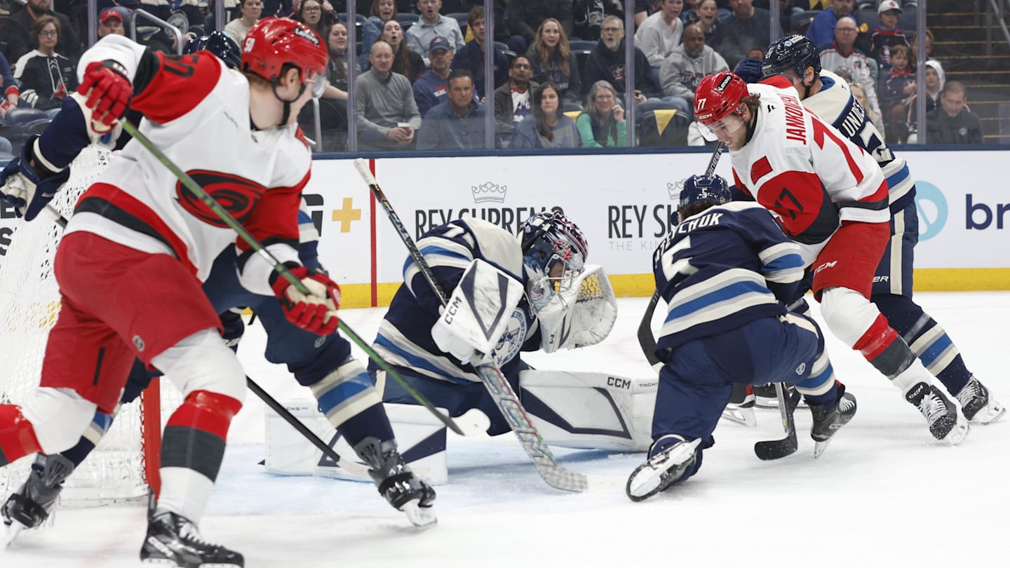 Mar 31, 2026; Columbus, Ohio, USA; Columbus Blue Jackets goalie Jet Greaves (73) makes a save as Carolina Hurricanes center Mark Jankowski (77) looks for a rebound during the first period at Nationwide Arena. Mandatory Credit: Russell LaBounty-Imagn Images