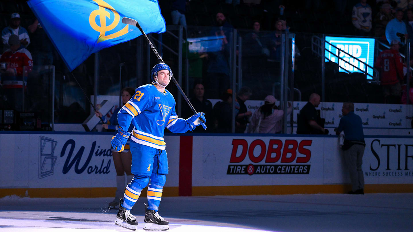 Mar 24, 2026; St. Louis, Missouri, USA; St. Louis Blues right wing Jimmy Snuggerud (21) salutes the fans after he was named second star of the game after a victory over the Washington Capitals at Enterprise Center. Mandatory Credit: Jeff Curry-Imagn Images