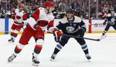 Mar 31, 2026; Columbus, Ohio, USA; Carolina Hurricanes defenseman Alexander Nikishin (21) passes the puck asColumbus Blue Jackets center Cole Sillinger (4) defends during the second period at Nationwide Arena. Mandatory Credit: Russell LaBounty-Imagn Images