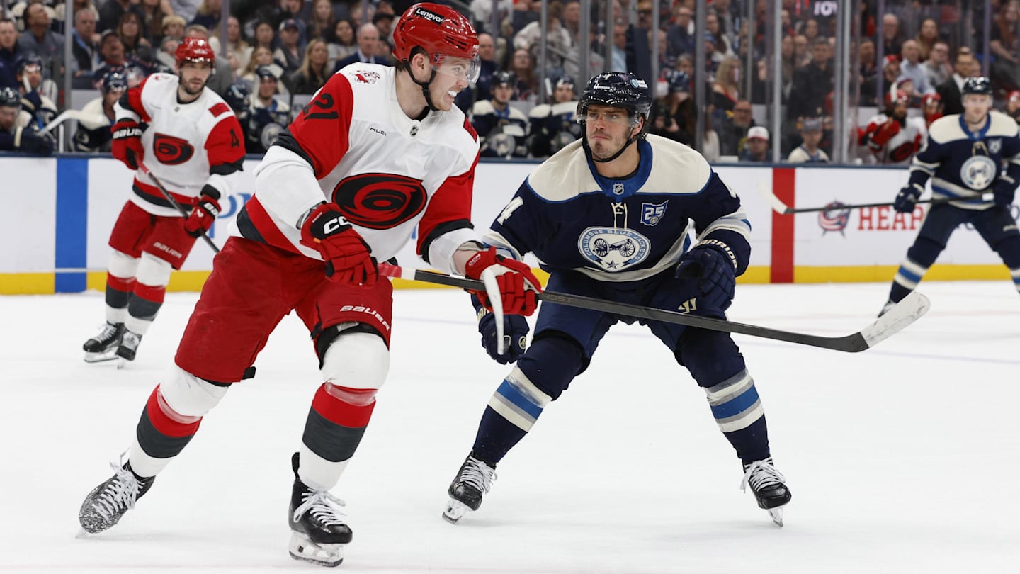 Mar 31, 2026; Columbus, Ohio, USA; Carolina Hurricanes defenseman Alexander Nikishin (21) passes the puck asColumbus Blue Jackets center Cole Sillinger (4) defends during the second period at Nationwide Arena. Mandatory Credit: Russell LaBounty-Imagn Images