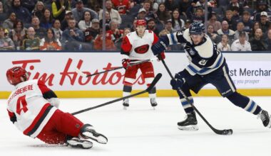 Mar 31, 2026; Columbus, Ohio, USA; Columbus Blue Jackets center Sean Monahan (23) wrists a shot on goal as Carolina Hurricanes defenseman Shayne Gostisbehere (4) defends during the second period at Nationwide Arena. Mandatory Credit: Russell LaBounty-Imagn Images