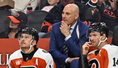 Oct 13, 2025; Philadelphia, Pennsylvania, USA; Philadelphia Flyers head coach Rick Tocchet with right wing Travis Konecny (11) and center Sean Couturier (14) against the Florida Panthers during the first period at Wells Fargo Center. Mandatory Credit: Eric Hartline-Imagn Images