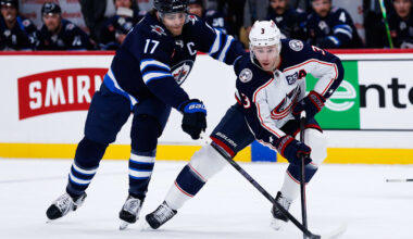 Nov 18, 2025; Winnipeg, Manitoba, CAN;  Columbus Blue Jackets forward Charlie Coyle (3) tries to skate away from Winnipeg Jets forward Adam Lowry (17) during the first period at Canada Life Centre. Mandatory Credit: Terrence Lee-Imagn Images