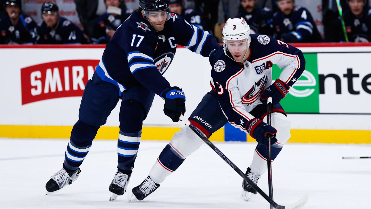 Nov 18, 2025; Winnipeg, Manitoba, CAN;  Columbus Blue Jackets forward Charlie Coyle (3) tries to skate away from Winnipeg Jets forward Adam Lowry (17) during the first period at Canada Life Centre. Mandatory Credit: Terrence Lee-Imagn Images