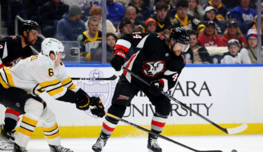 Dec 27, 2025; Buffalo, New York, USA;  Boston Bruins defenseman Mason Lohrei (6) defends as Buffalo Sabres center Josh Dunne (44) tries to control the puck during the second period at KeyBank Center. Mandatory Credit: Timothy T. Ludwig-Imagn Images