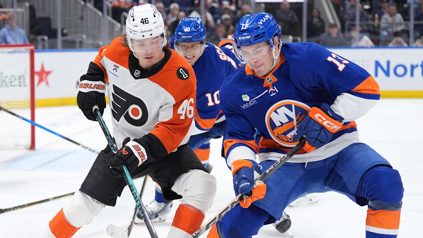 Apr 3, 2026; Elmont, New York, USA;  Philadelphia Flyers forward Trevor Zegras (46) and New York Islanders fordward Mathew Barzal (13) battle for a puck during the third period at UBS Arena. Mandatory Credit: Alexander Wohl-Imagn Images