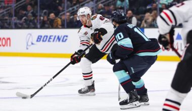 Nov 3, 2025; Seattle, Washington, USA; Chicago Blackhawks defenseman Sam Rinzel (6) passes the puck past Seattle Kraken center Matty Beniers (10) in the first period at Climate Pledge Arena. Mandatory Credit: Kevin Ng-Imagn Images