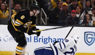 Mar 24, 2026; Boston, Massachusetts, USA; Boston Bruins defenseman Mason Lohrei (6) knocks down Toronto Maple Leafs center Bo Groulx (29) during the first period at TD Garden. Mandatory Credit: Winslow Townson-Imagn Images