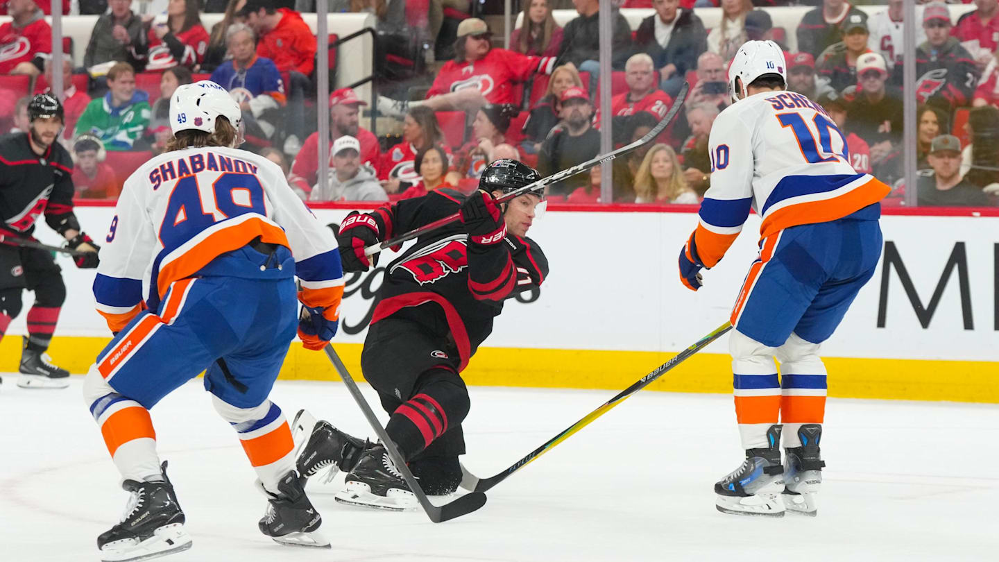 Apr 4, 2026; Raleigh, North Carolina, USA;  Carolina Hurricanes left wing Taylor Hall (71) takes a shot against New York Islanders center Brayden Schenn (10) and right wing Max Shabanov (49) during the third period at Lenovo Center. Mandatory Credit: James Guillory-Imagn Images