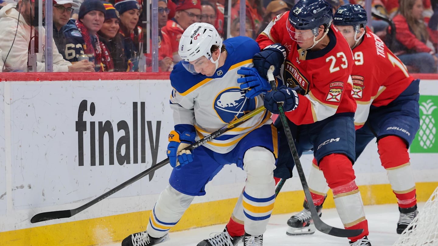 Feb 2, 2026; Sunrise, Florida, USA; Buffalo Sabres defenseman Michael Kesselring (8) protects the puck against Florida Panthers center Carter Verhaeghe (23) during the first period at Amerant Bank Arena. Mandatory Credit: Sam Navarro-Imagn Images