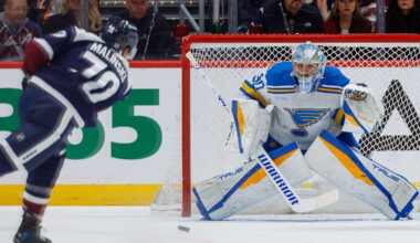 Apr 5, 2026; Denver, Colorado, USA; St. Louis Blues goaltender Joel Hofer (30) defends on a shot from Colorado Avalanche defenseman Sam Malinski (70) in the first period at Ball Arena. Mandatory Credit: Isaiah J. Downing-Imagn Images