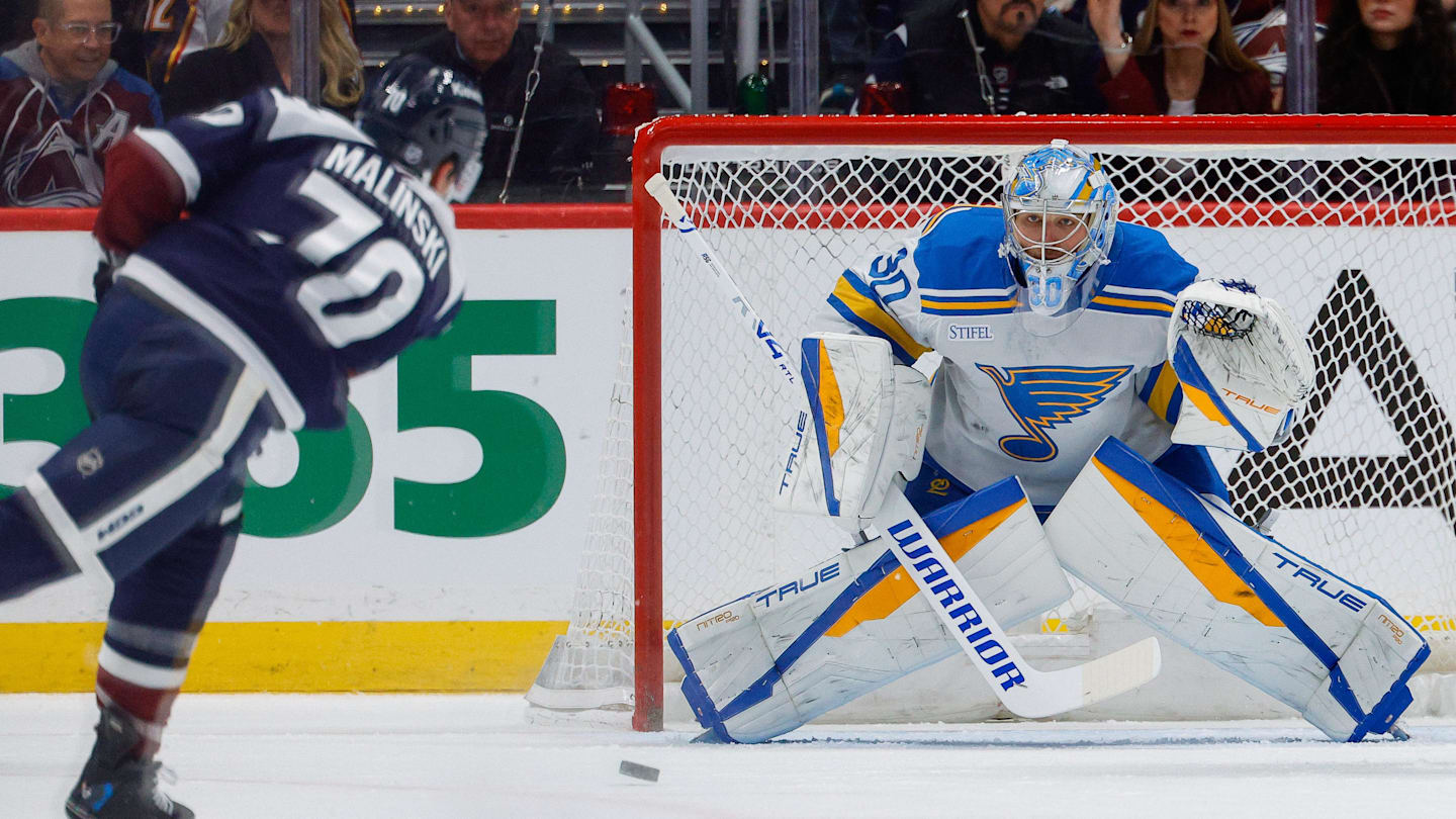 Apr 5, 2026; Denver, Colorado, USA; St. Louis Blues goaltender Joel Hofer (30) defends on a shot from Colorado Avalanche defenseman Sam Malinski (70) in the first period at Ball Arena. Mandatory Credit: Isaiah J. Downing-Imagn Images