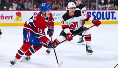 Apr 5, 2026; Montreal, Quebec, CAN; Montreal Canadiens right wing Cole Caufield (13) plays the puck against New Jersey Devils center Marc McLaughlin (21) during the first period at Bell Centre. Mandatory Credit: David Kirouac-Imagn Images
