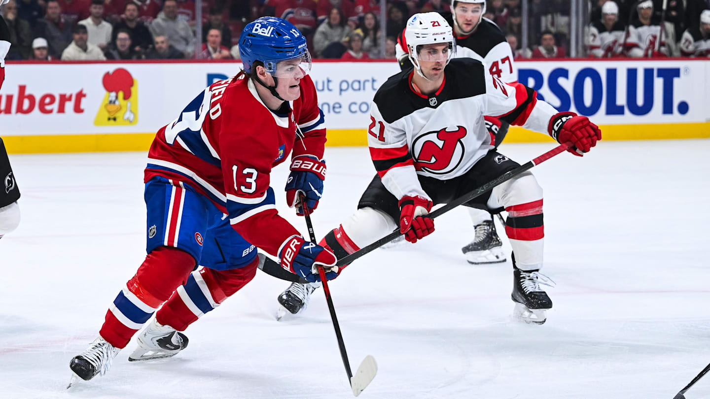 Apr 5, 2026; Montreal, Quebec, CAN; Montreal Canadiens right wing Cole Caufield (13) plays the puck against New Jersey Devils center Marc McLaughlin (21) during the first period at Bell Centre. Mandatory Credit: David Kirouac-Imagn Images