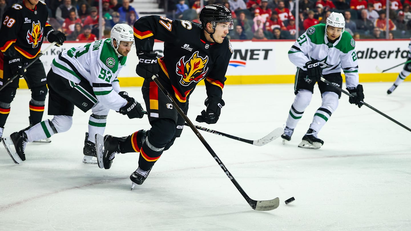 Mar 3, 2026; Calgary, Alberta, CAN; Calgary Flames defenseman Yan Kuznetsov (37) skates with the puck against the Dallas Stars during the first period at Scotiabank Saddledome. Mandatory Credit: Sergei Belski-Imagn Images