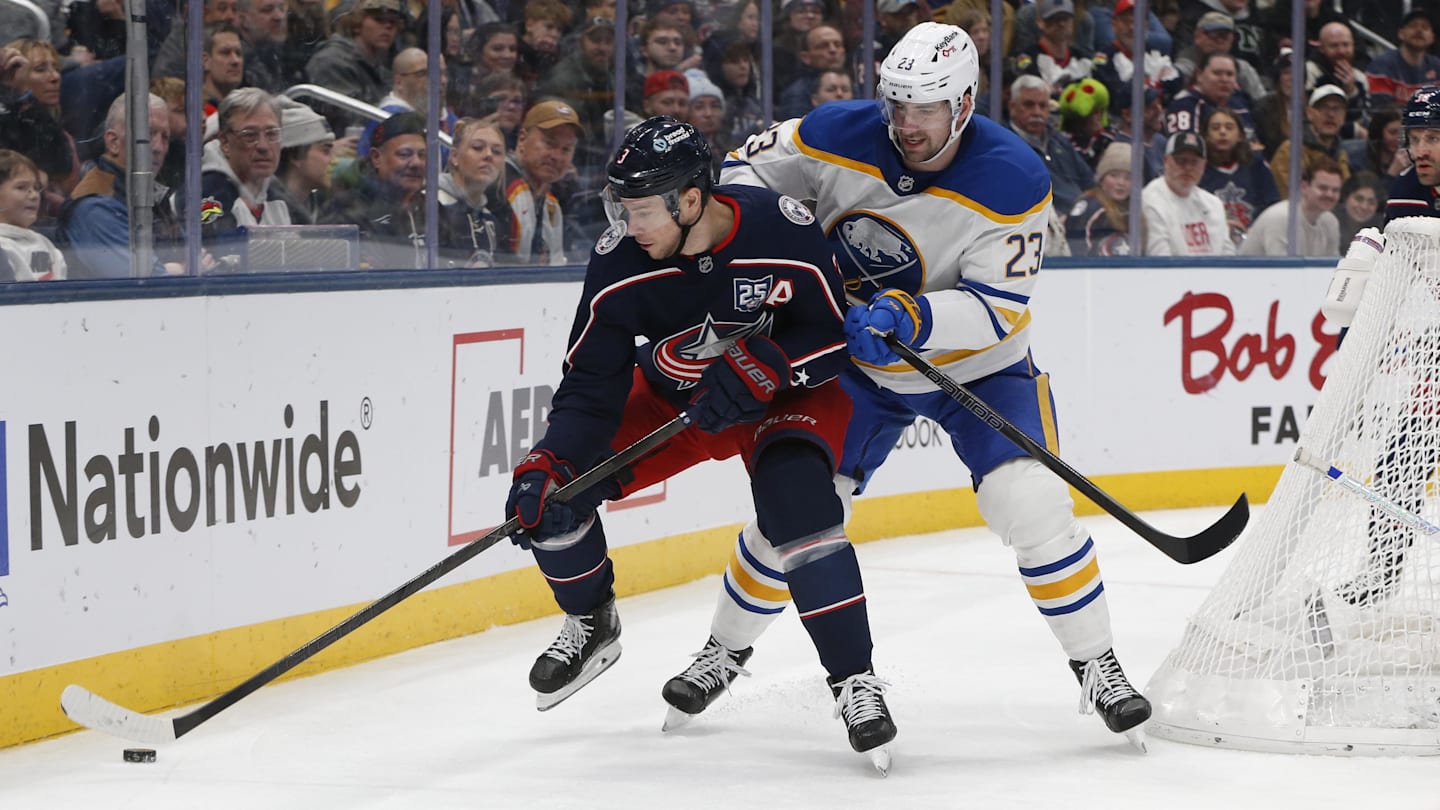 Jan 3, 2026; Columbus, Ohio, USA; Columbus Blue Jackets center Charlie Coyle (3) and Buffalo Sabres defenseman Mattias Samuelsson (23) battle for the loose puck during the second period at Nationwide Arena. Mandatory Credit: Russell LaBounty-Imagn Images