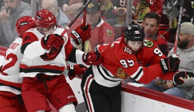 Apr 9, 2026; Chicago, Illinois, USA;  Carolina Hurricanes defenseman Mike Reilly (6) checks Chicago Blackhawks right wing Ilya Mikheyev (95) during the second period at the United Center. Mandatory Credit: Matt Marton-Imagn Images