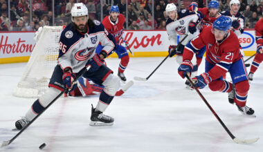 Mar 26, 2026; Montreal, Quebec, CAN; Columbus Blue Jackets forward Kirill Marchenko (86) plays the puck and Montreal Canadiens defenseman Kaiden Guhle (21) defends during the third period at the Bell Centre. Mandatory Credit: Eric Bolte-Imagn Images