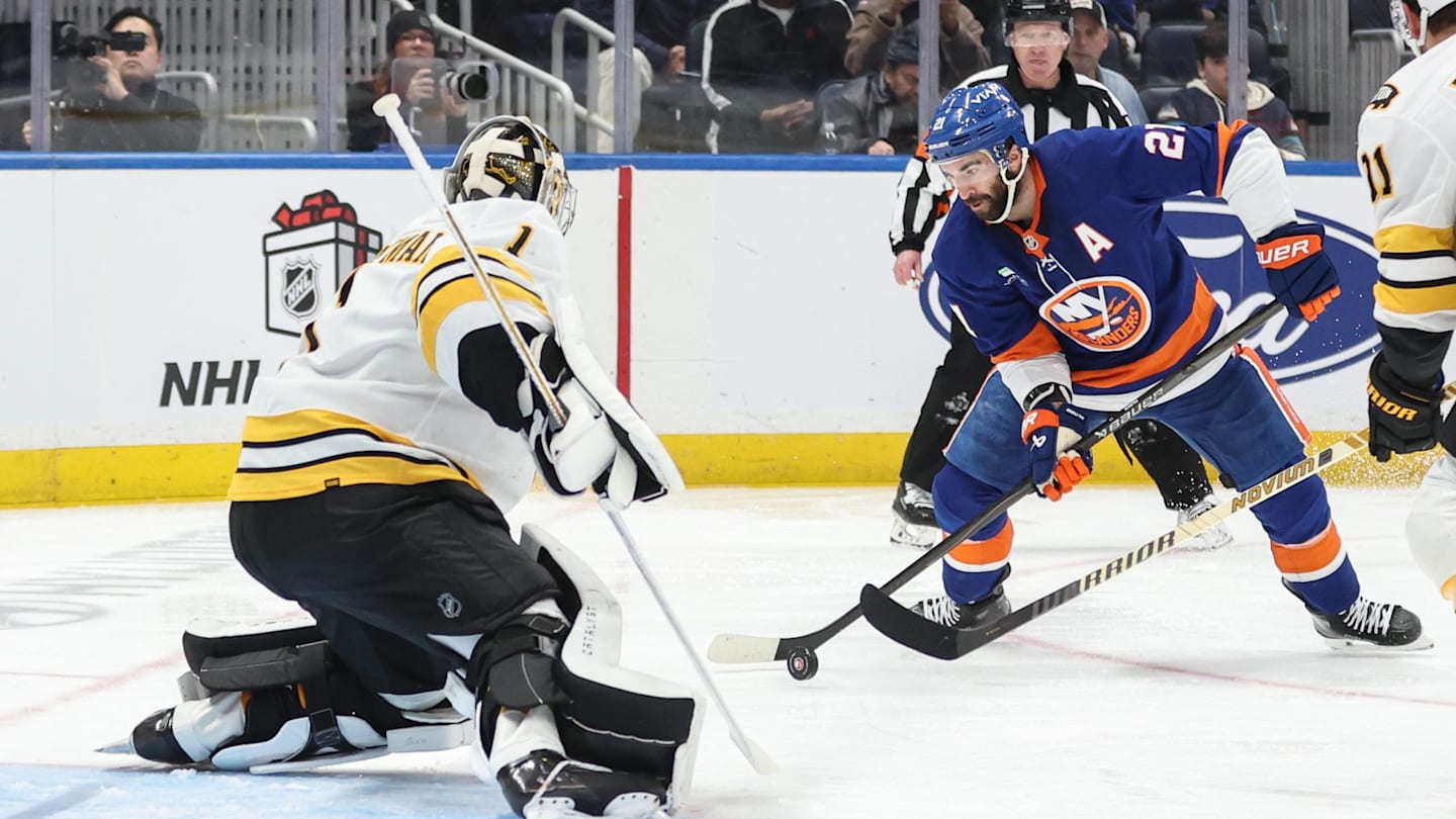 Nov 26, 2025; Elmont, New York, USA; Boston Bruins goaltender Jeremy Swayman (1) defends against a shot on goal attempt from New York Islanders center Kyle Palmieri (21) in the second period at UBS Arena. Mandatory Credit: Wendell Cruz-Imagn Images