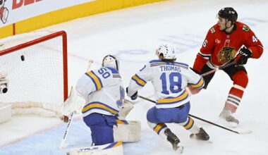 Jan 7, 2026; Chicago, Illinois, USA;  Chicago Blackhawks defenseman Louis Crevier (46) scores a goal past St. Louis Blues goaltender Jordan Binnington (50) and center Robert Thomas (18) during the third period at the United Center. Mandatory Credit: Matt Marton-Imagn Images