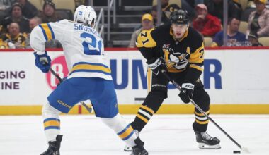 Oct 27, 2025; Pittsburgh, Pennsylvania, USA; Pittsburgh Penguins center Evgeni Malkin (71) skates with the puck against St. Louis Blues right wing Jimmy Snuggerud (21) during the third period at PPG Paints Arena. Mandatory Credit: Charles LeClaire-Imagn Images