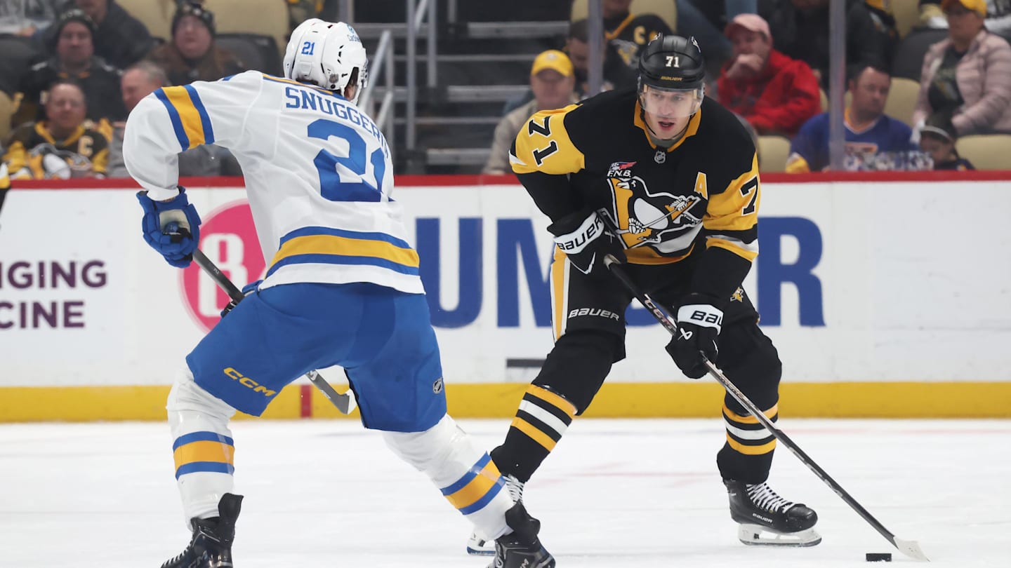 Oct 27, 2025; Pittsburgh, Pennsylvania, USA; Pittsburgh Penguins center Evgeni Malkin (71) skates with the puck against St. Louis Blues right wing Jimmy Snuggerud (21) during the third period at PPG Paints Arena. Mandatory Credit: Charles LeClaire-Imagn Images