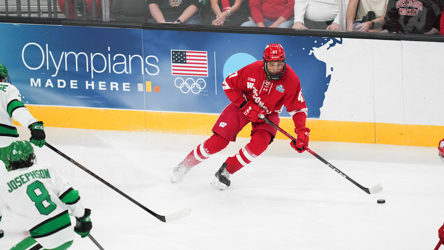 Apr 9, 2026; Las Vegas, Nevada, UNITED STATES; Wisconsin Badgers forward Blake Montgomery (47) moves the puck in the second period against the North Dakota Fighting Hawks in the semifinals of the NCAA men's ice hockey Frozen Four at T-Mobile Arena. Mandatory Credit: Lucas Peltier-Imagn Images