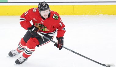 Jan 12, 2026; Chicago, Illinois, USA; Chicago Blackhawks center Oliver Moore (11) looks to pass the puck against the Edmonton Oilers during the first period at United Center. Mandatory Credit: Kamil Krzaczynski-Imagn Images