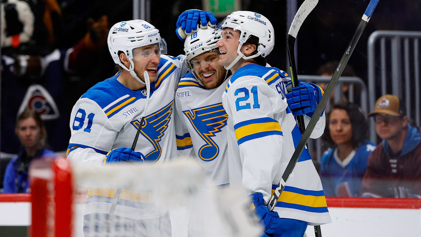 Apr 5, 2026; Denver, Colorado, USA; St. Louis Blues center Robert Thomas (18) celebrates his third goal of the game with left wing Dylan Holloway (81) and right wing Jimmy Snuggerud (21) in the third period against the Colorado Avalanche at Ball Arena. Mandatory Credit: Isaiah J. Downing-Imagn Images