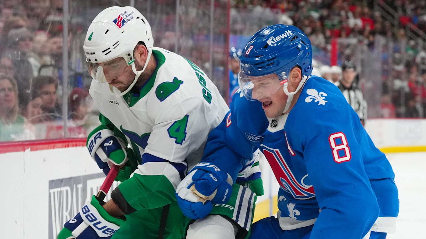Jan 3, 2026; Raleigh, North Carolina, USA; Colorado Avalanche defenseman Cale Makar (8) checks Carolina Hurricanes defenseman Shayne Gostisbehere (4) during the third period at Lenovo Center. Mandatory Credit: James Guillory-Imagn Images