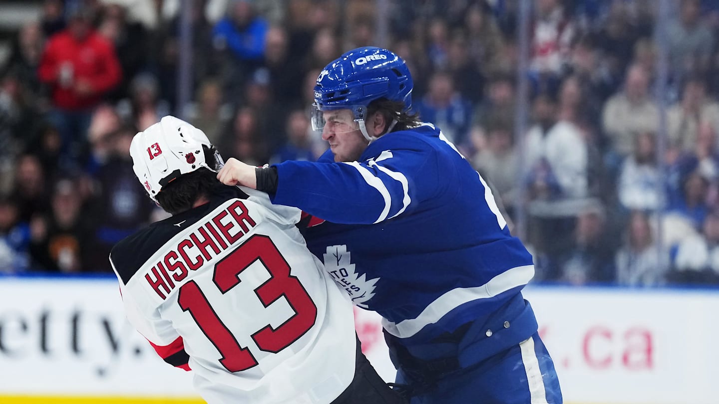 Toronto Maple Leafs left wing Matthew Knies (23) fights with New Jersey Devils center Nico Hischier (13): Nick Turchiaro-Imagn Images