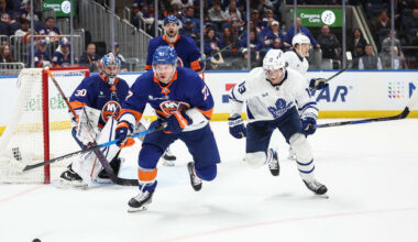 Apr 9, 2026; Elmont, New York, USA;  New York Islanders defenseman Tony DeAngelo (77) and Toronto Maple Leafs center Calle Jarnkrok (19) chase after the puck in the third period at UBS Arena. Mandatory Credit: Wendell Cruz-Imagn Images