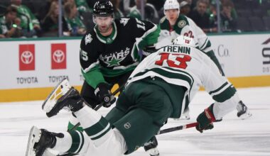 Apr 18, 2026; Dallas, Texas, USA;Minnesota Wild center Yakov Trenin (13) is tripped while skating with the puck against Dallas Stars center Colin Blackwell (15) in the third period in game one of the first round of the 2026 Stanley Cup Playoffs at American Airlines Center. Mandatory Credit: Thomas Shea-Imagn Images