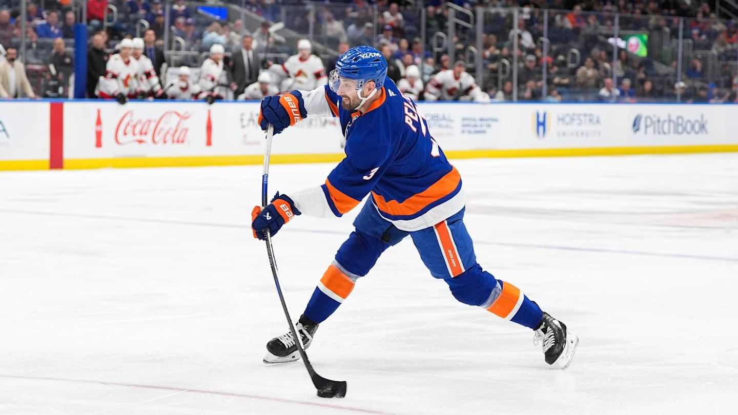 Apr 11, 2026; Elmont, New York, USA; New York Islanders defenseman Adam Pelech (3) shoots the puck in the second period at UBS Arena. Mandatory Credit: Alexander Wohl-Imagn Images
