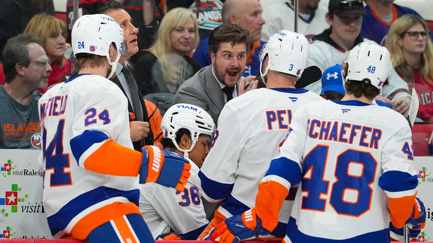 Apr 4, 2026; Raleigh, North Carolina, USA;  New York Islanders assistant coach Benoit Desrosiers talks to defenseman Scott Mayfield (24) defenseman Ryan Pulock (6) defenseman Isaiah George (36) and defenseman Matthew Schaefer (48) against the Carolina Hurricanes during the first period at Lenovo Center. Mandatory Credit: James Guillory-Imagn Images