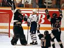 Los Angeles Kings' goaltender Kelly Hrudey celebrates winning the final game of the Campbell Conference playoffs in front of a dejected Toronto Maple Leafs' Doug Gilmour.