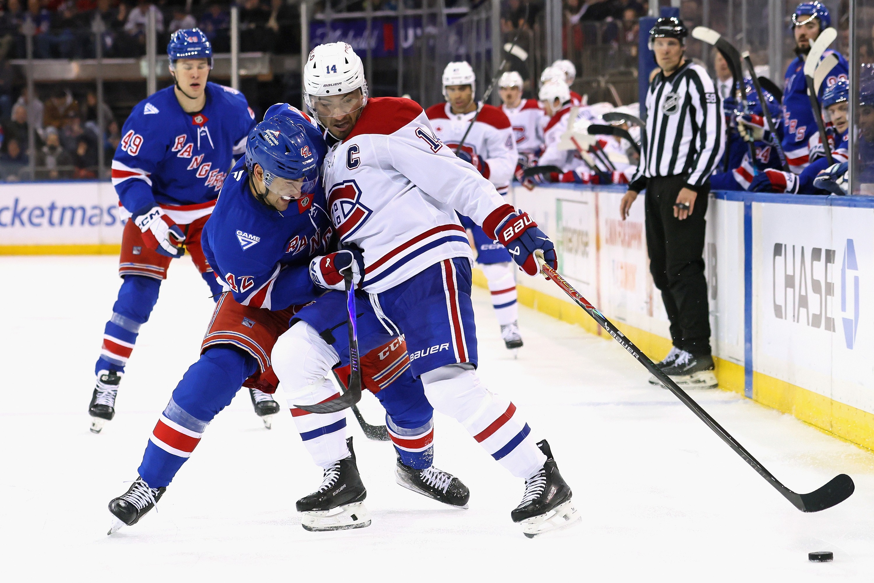 Canadiens captain Nick Suzuki holds off Rangers' Noah Laba during the third period in New York on Thursday night.