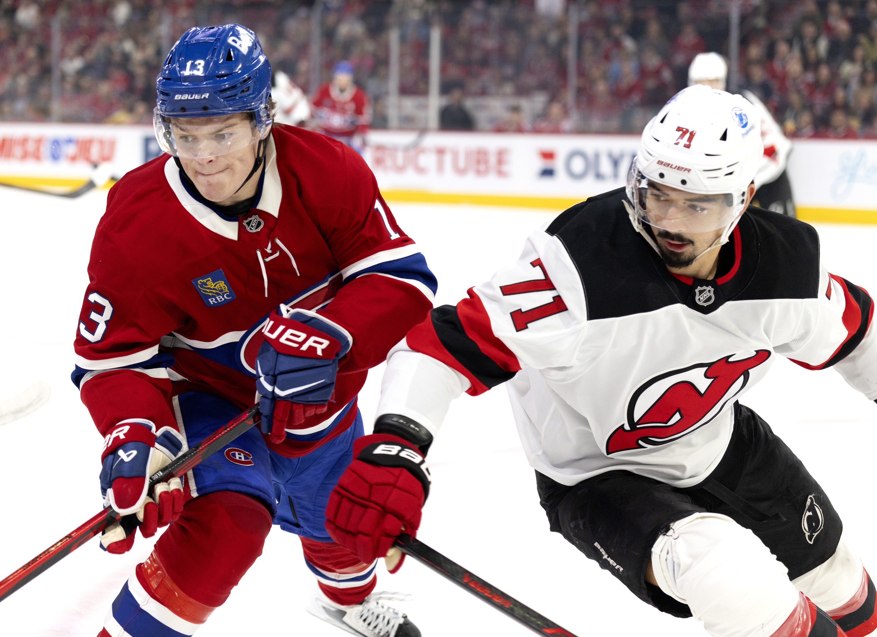 Montreal Canadiens right wing Cole Caufield and New Jersey Devils defenceman Jonas Siegenthaler race to the corner.