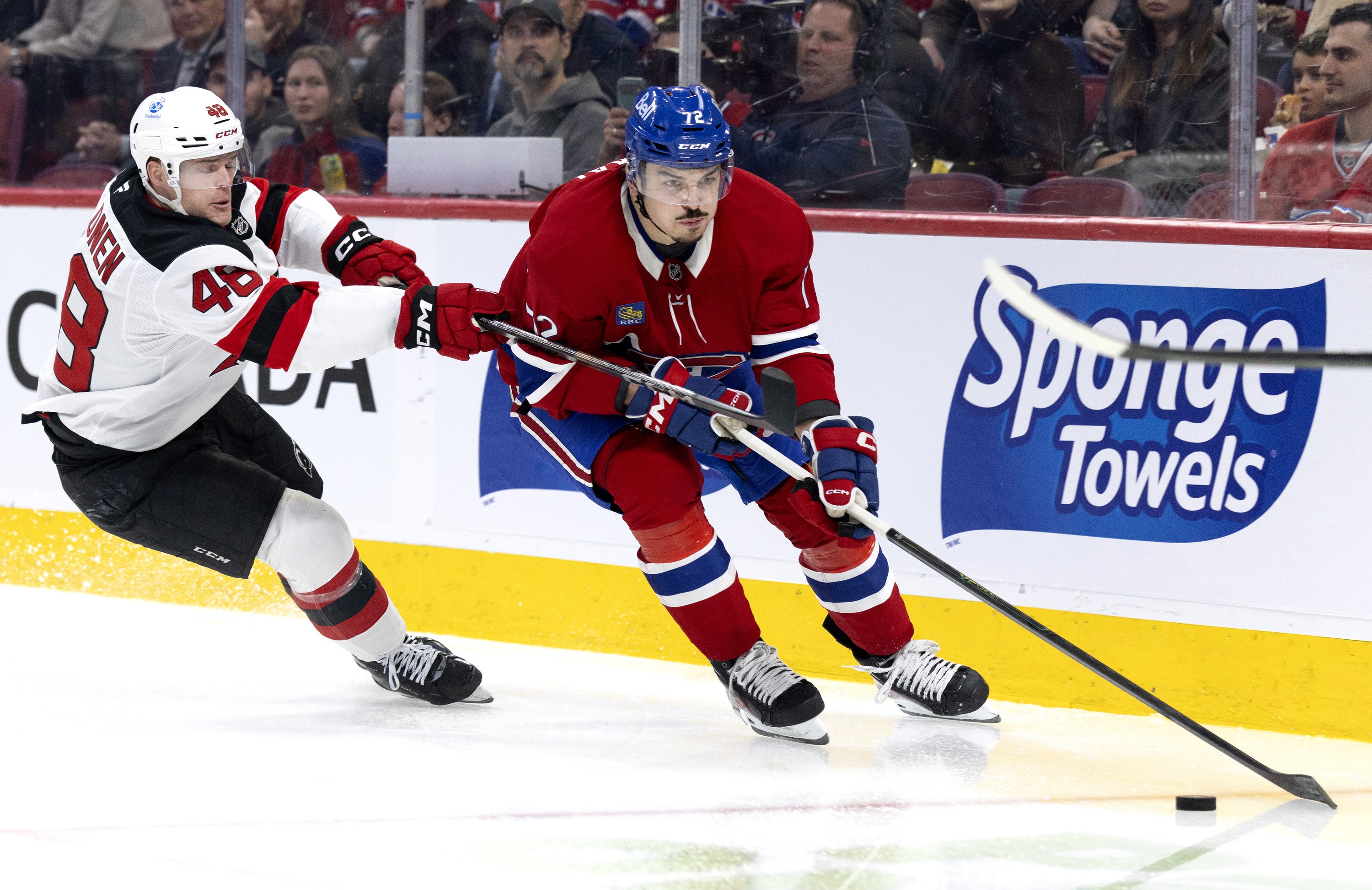 New Jersey Devils left wing Brian Halonen tries to stop Montreal Canadiens defenceman Arber Xhekaj.