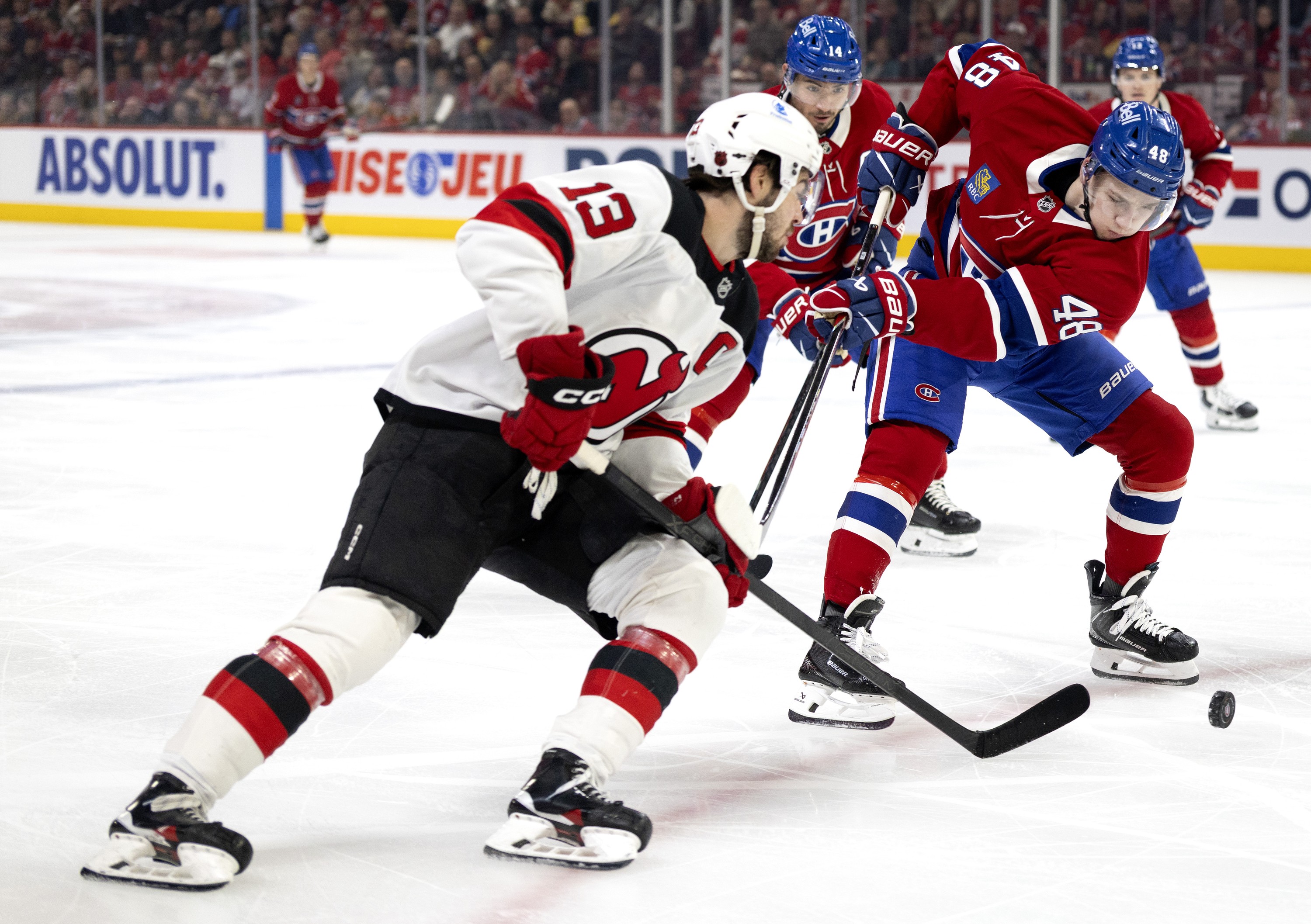 Montreal Canadiens defenceman Lane Hutson breaks up New Jersey Devils centre Nico Hischier's drive for the net.