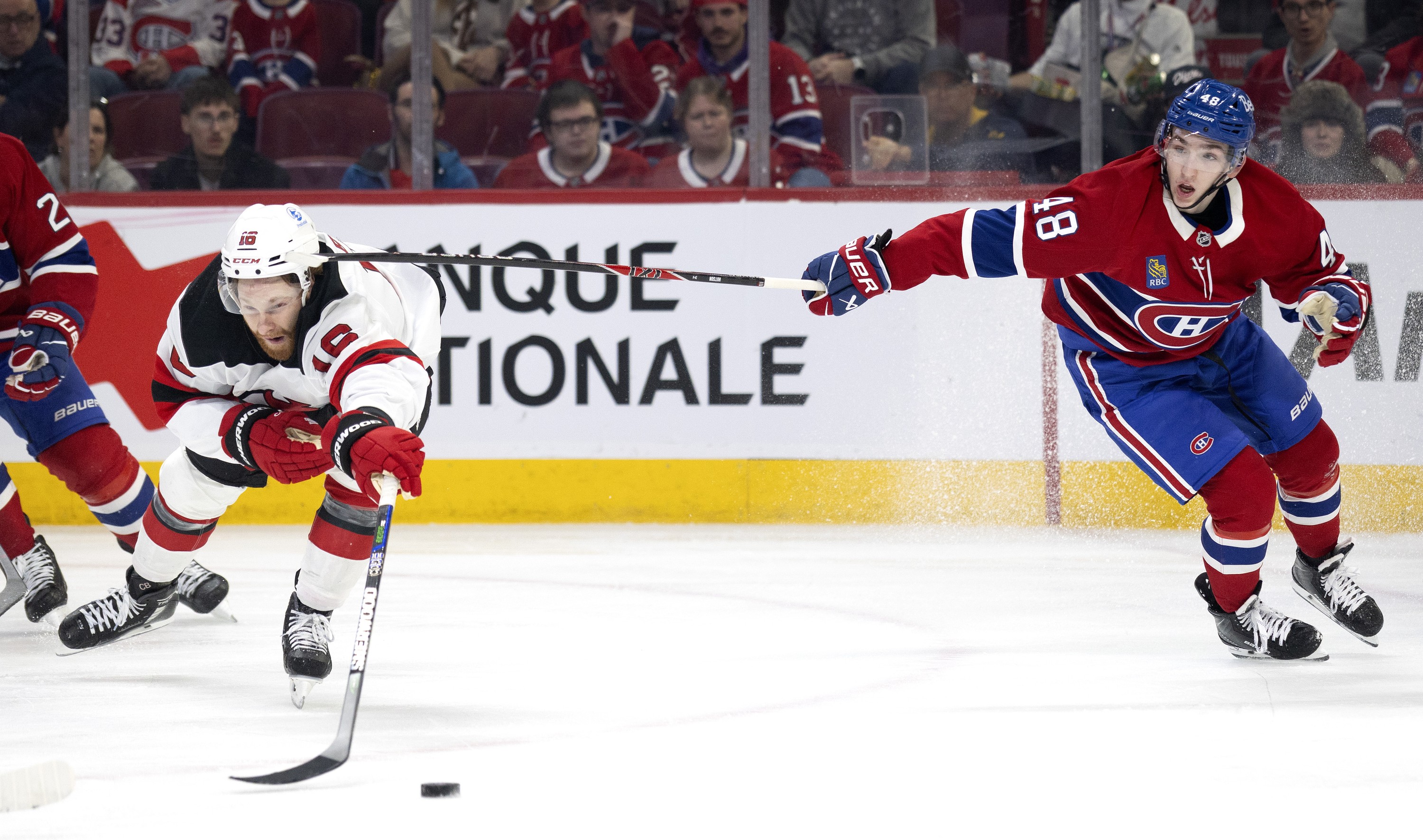 Montreal Canadiens defenceman Lane Hutson high-sticks New Jersey Devils right wing Connor Brown.
