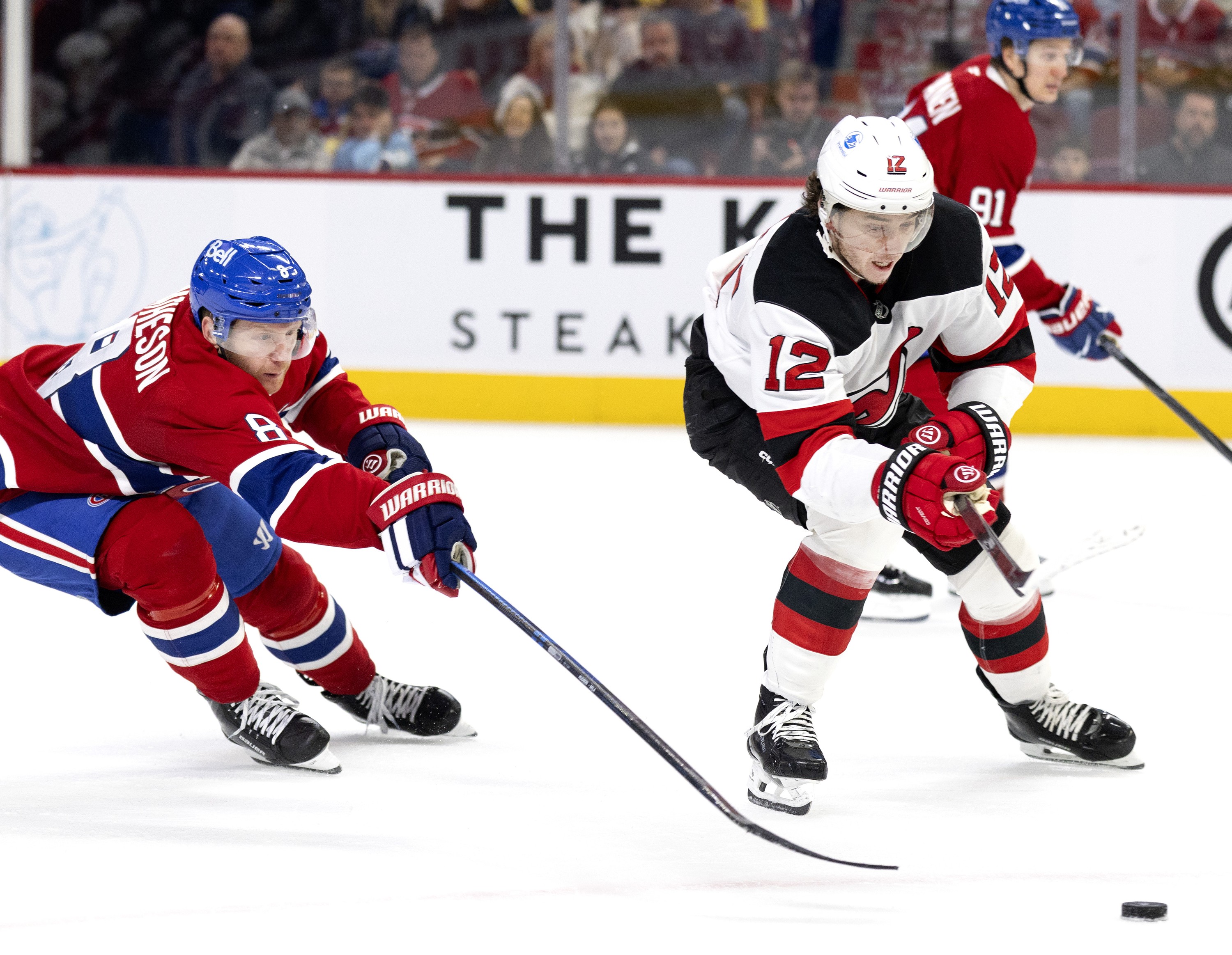 Montreal Canadiens defenceman Mike Matheson chases New Jersey Devils centre Cody Glass.