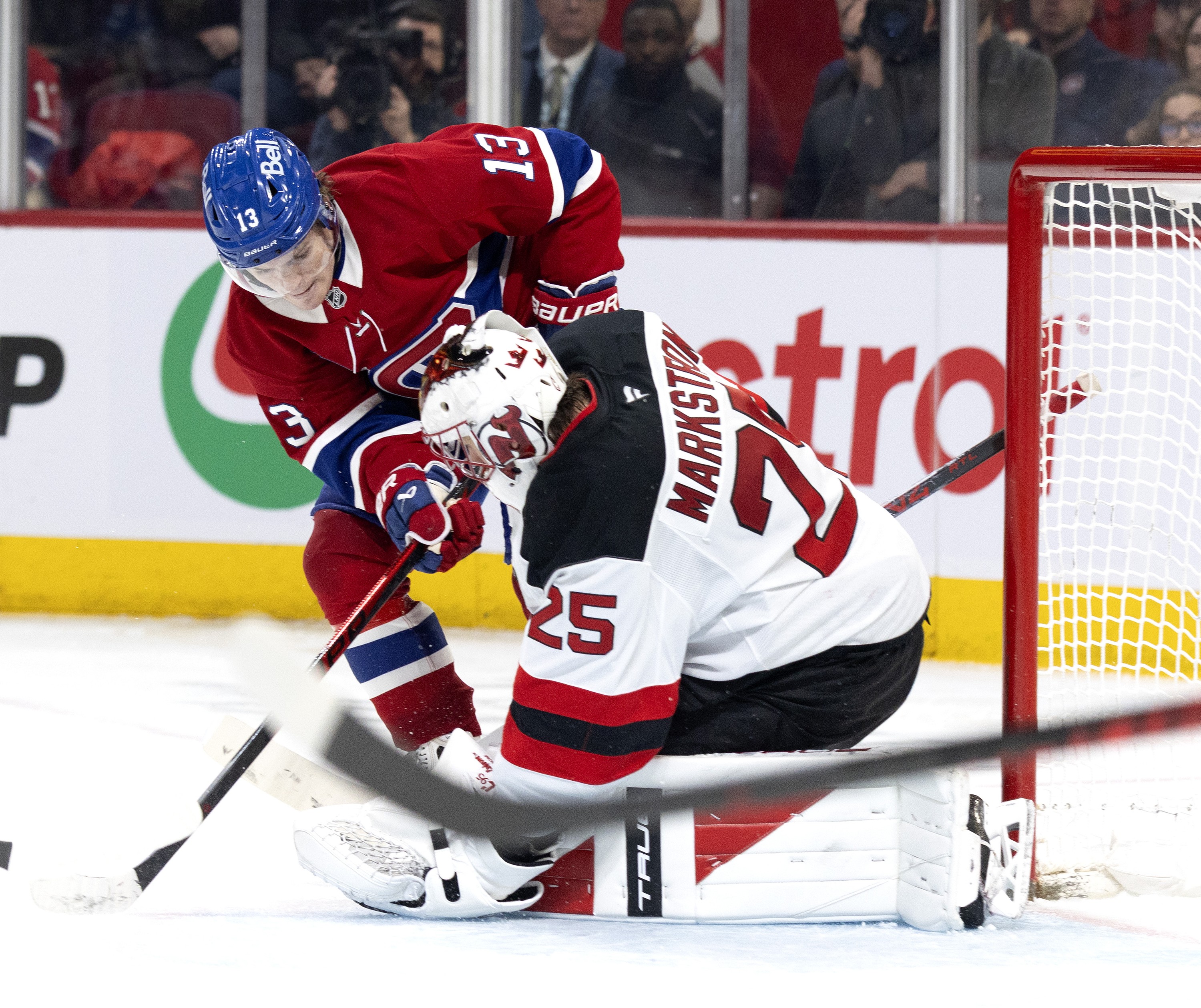Montreal Canadiens right wing Cole Caufield looks for a rebound from New Jersey Devils goaltender Jacob Markstrom.