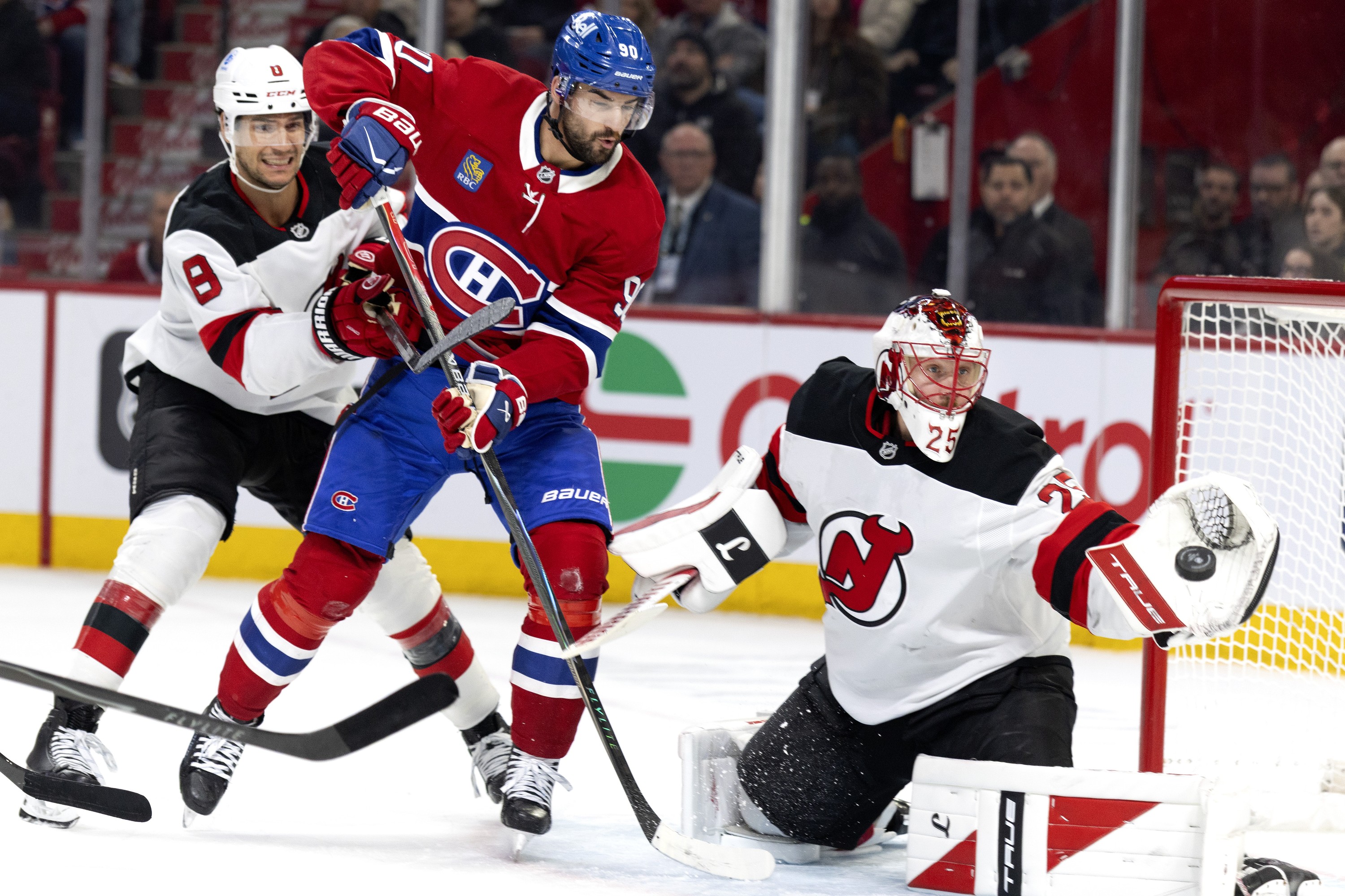 "Every time I have an opportunity to hit someone, I feel like it's going to pay off," says Canadiens forward Joe Veleno, watching teammate Lane Hutson's shot go wide on New Jersey Devils goaltender Jacob Markstrom as Johnathan Kovacevic defends during first period in Montreal on Sunday.