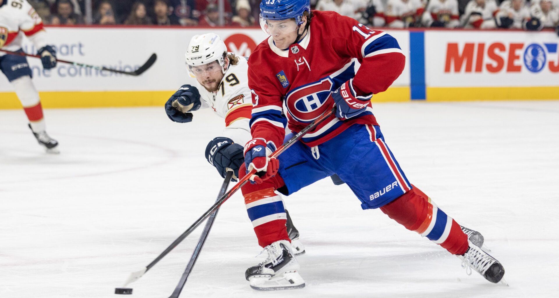 Canadiens sniper Cole Caufield unloads a backhand shot at the Florida net while being pressured by Panthers