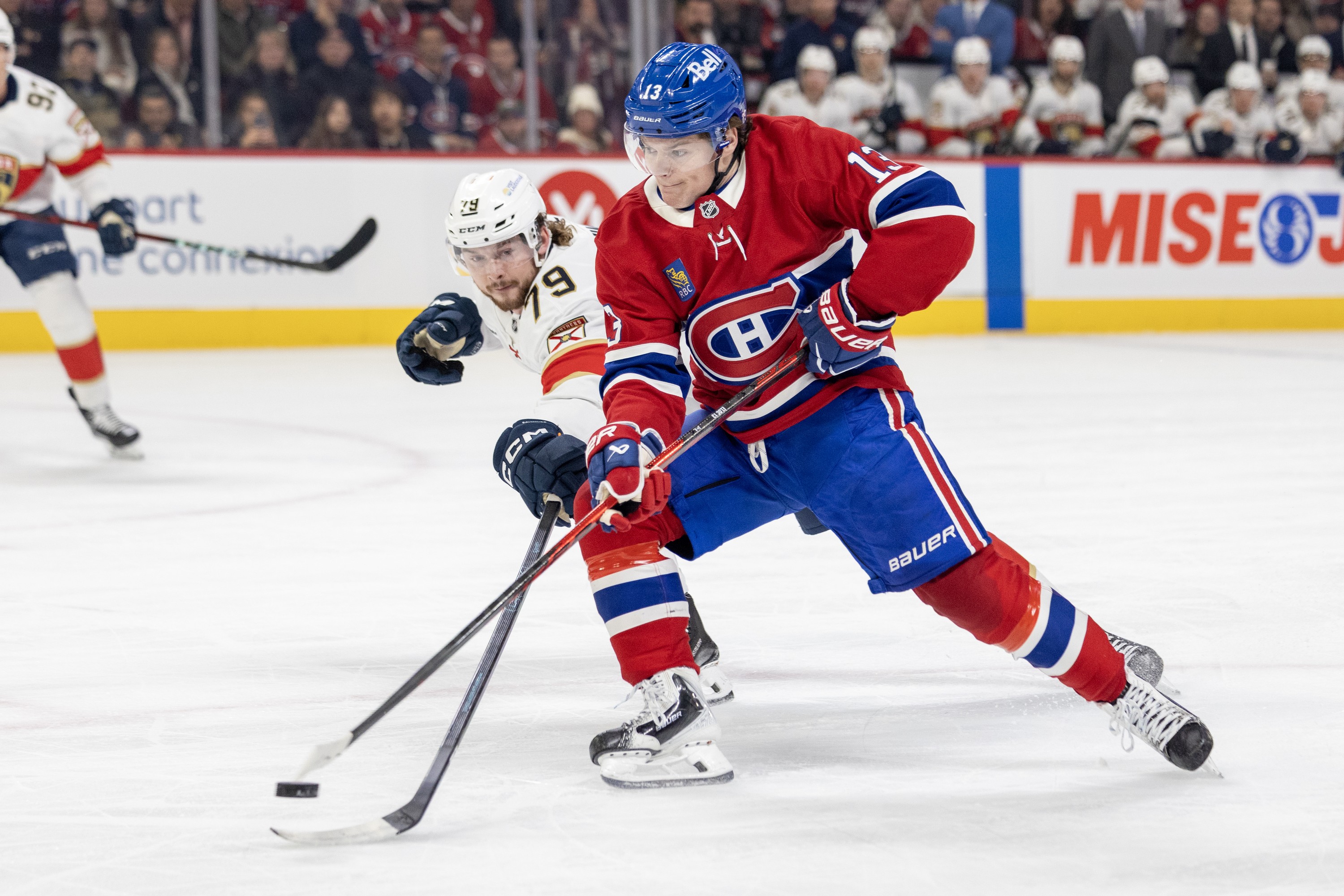 Canadiens sniper Cole Caufield unloads a backhand shot at the Florida net while being pressured by Panthers' Cole Schwindt during the first period in Montreal on Tuesday.