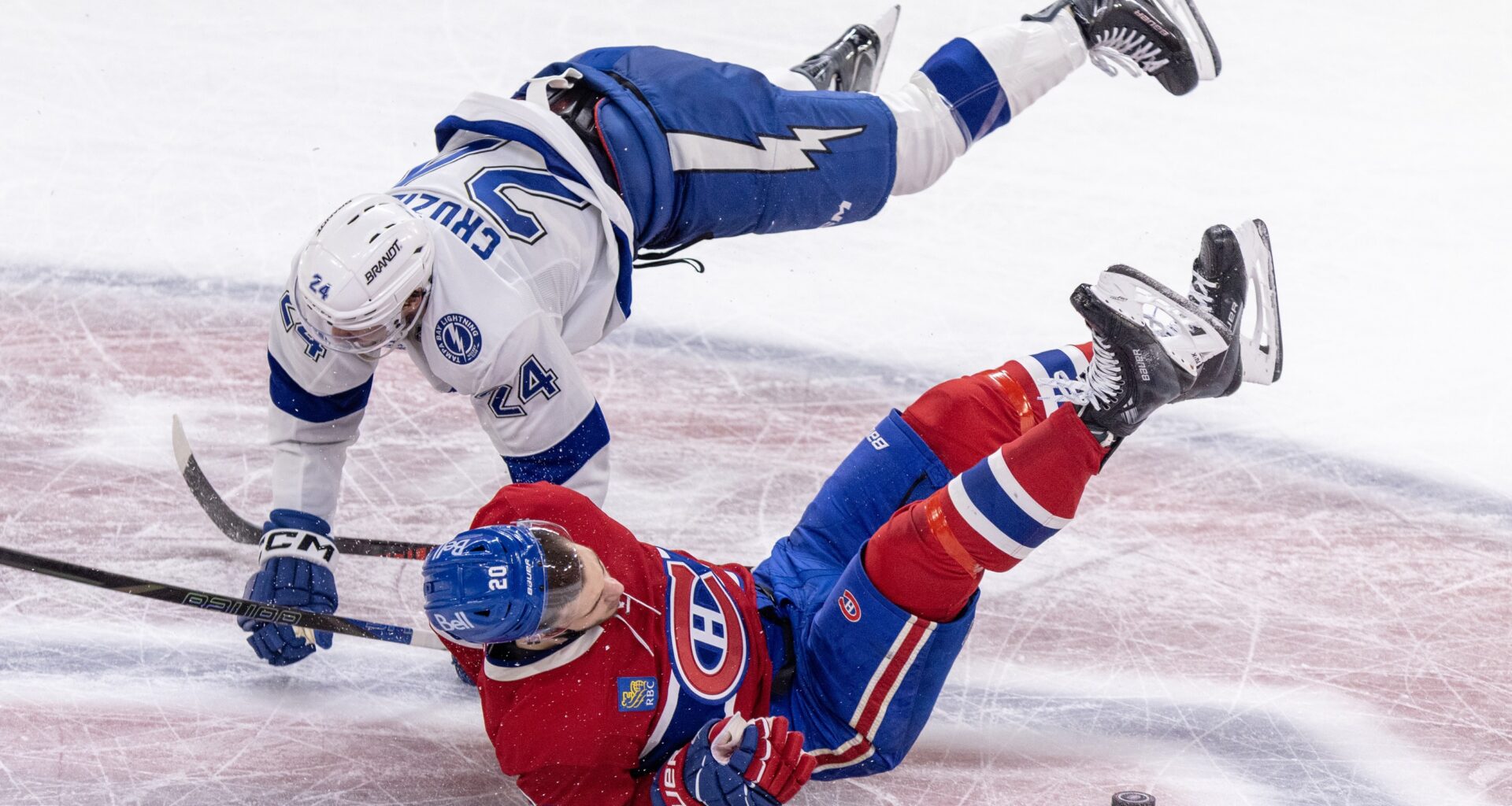 Montreal Canadiens' Juraj Slafkovsky is checked by Tampa Bay Lightning's Max Crozier.