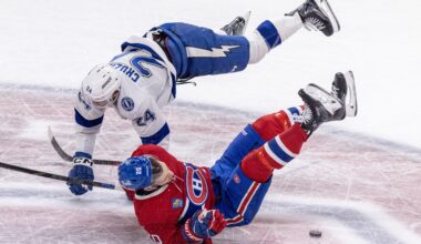 Montreal Canadiens' Juraj Slafkovsky is checked by Tampa Bay Lightning's Max Crozier.